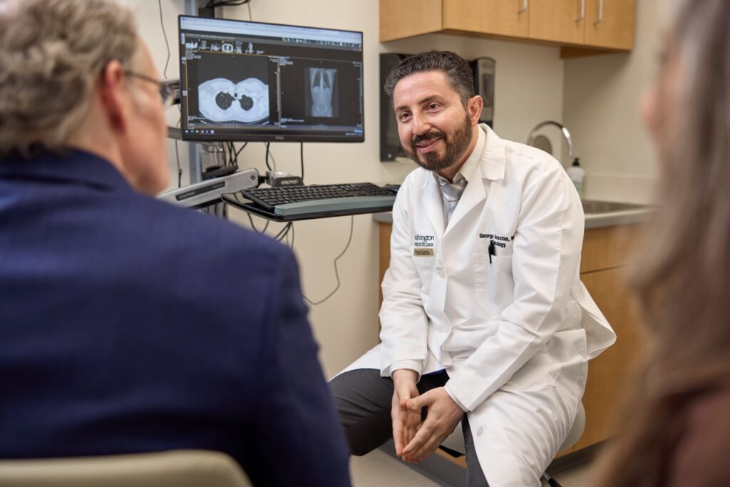 Physician talking with a patient and his wife about treatment options