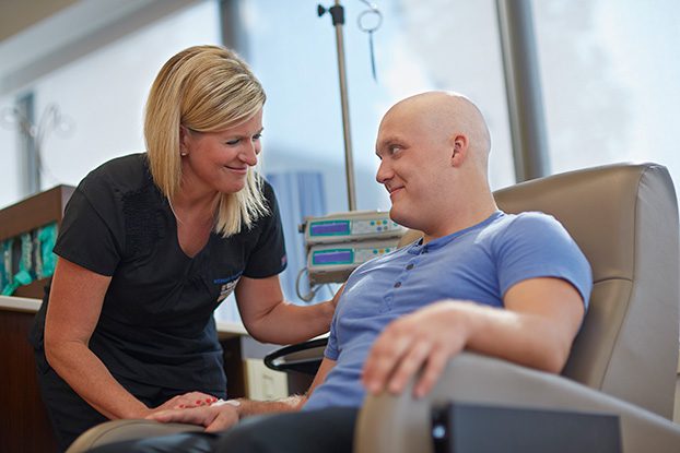 a nurse trained in oncology treating a patient