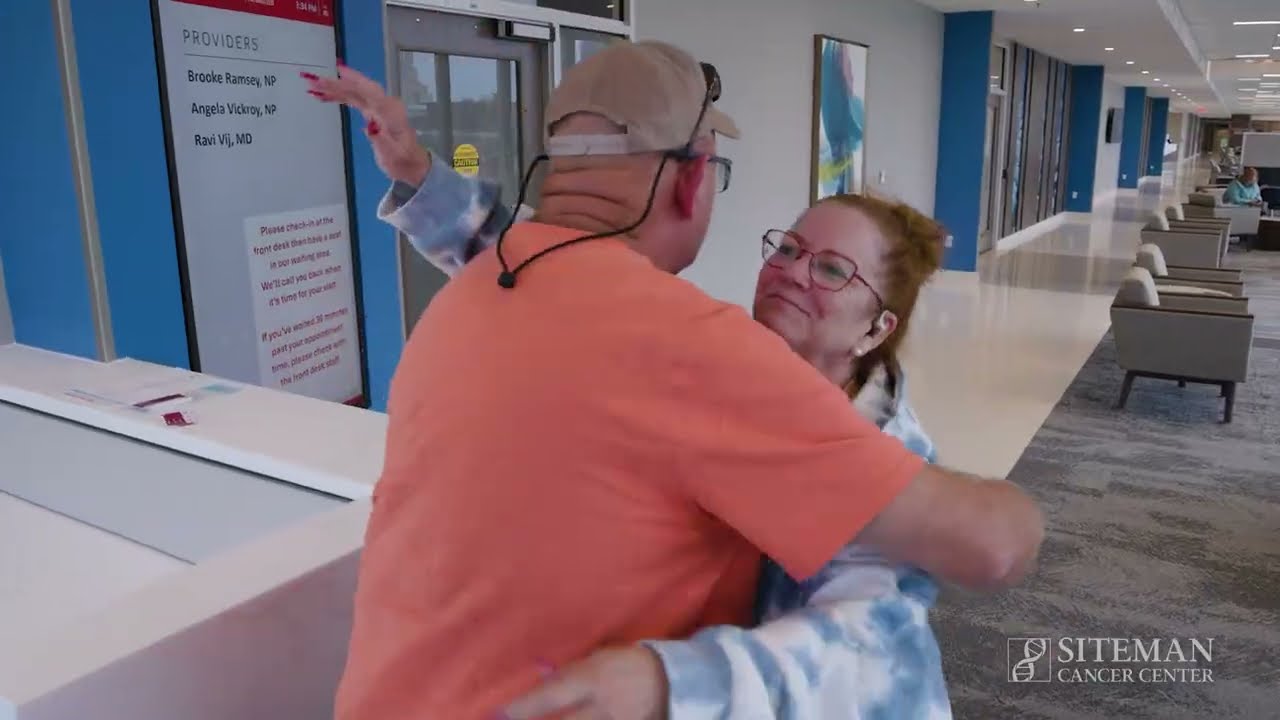 man hugging woman in waiting room