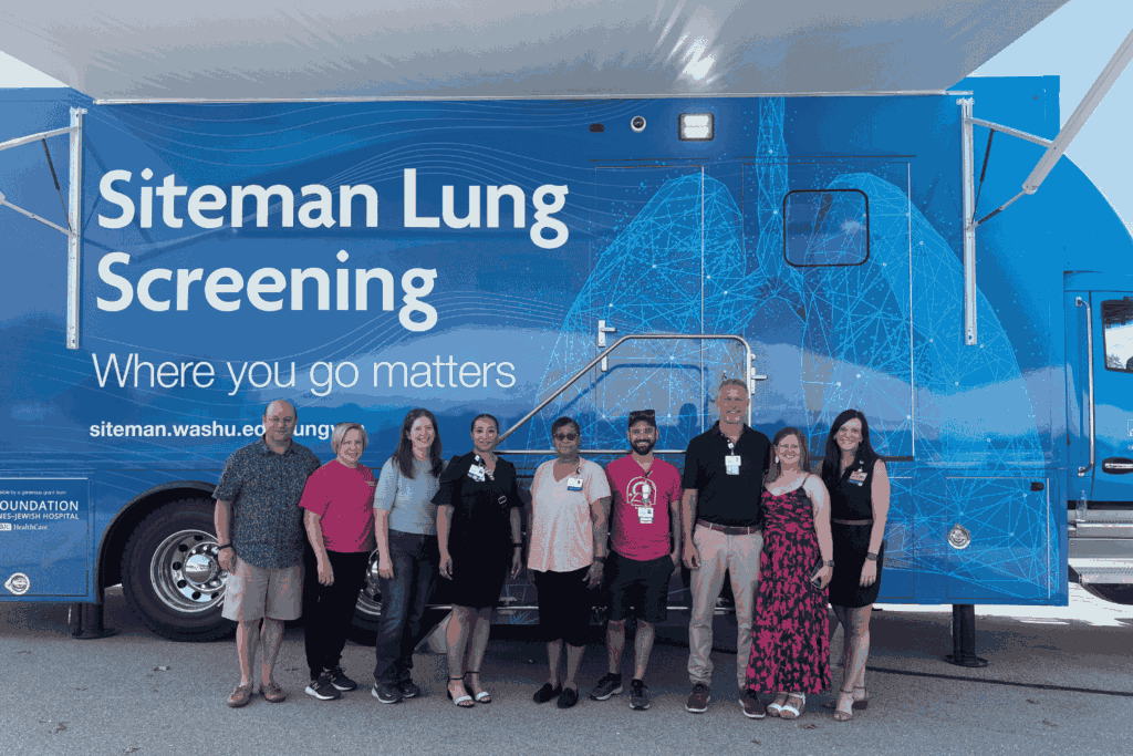 Community members and faculty members and staff attend an unveiling ceremony for the new Siteman Lung Screening Van.